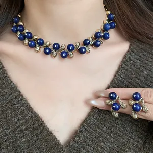 Elegant vintage style dark blue resin bead necklace and matching earring set on model