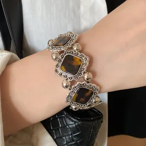Detail view of vintage bohemian elastic bracelet with rhombus acrylic and silver beads