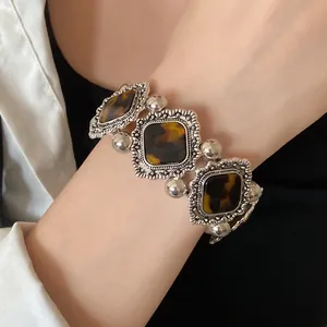 Vintage bohemian stretch bracelet featuring tortoiseshell acrylic insets on a wrist