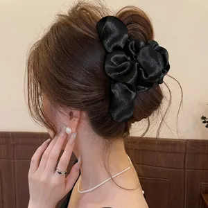 Elegant black satin floral hair claw clip for women's bun hairstyles, premium hair accessory