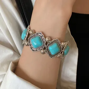 Detailed view of bohemian vintage stretch bracelet with blue rhombus acrylic stones