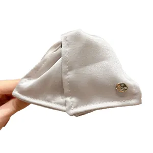 Elegant satin triangle hair claw clip with golden emblem for stylish women hair styling.
