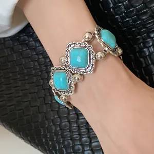 Detailed view of Bohemian turquoise stretch bracelet featuring ornate silver frames on wrist