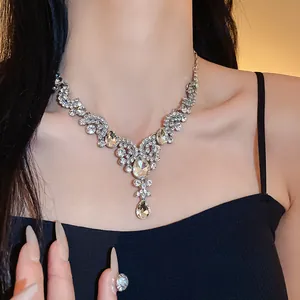 Vista dettagliata di un'elegante collana di strass con ciondolo a goccia su modella