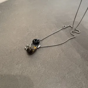 Macro view of natural tiger eye stone water drop pendant necklace with silver chain