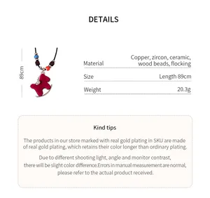 Detail view of red flocked horse pendant necklace with copper and zircon material