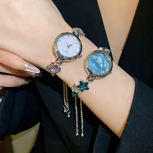 Elegant star charm bracelet watch with rhinestone accents and vintage metal band