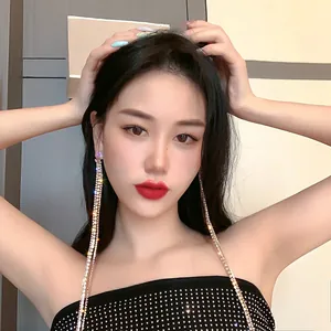Exquisite long sparkling rhinestone tassel earrings worn by an elegant female model