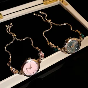 Elegant vintage-style rhinestone star charm bracelet watches in pink and iridescent blue