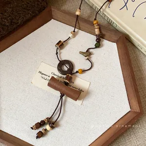 Vintage bohemian long necklace featuring wood beads, coconut shell and ceramic pendants