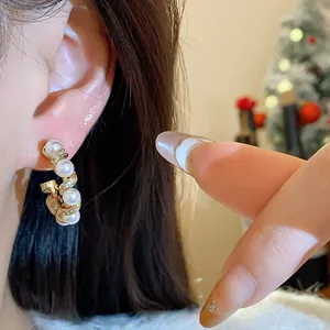 Close-up of elegant 18k gold plated hoop earrings with pearls and zircons