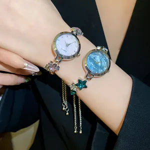 Detail of elegant star-motif watch bracelets with diamond accents and thin metal chains