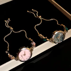 Macro view of vintage star bracelet watches with pink and blue quartz dials.
