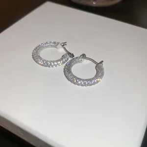 Vista dettagliata di orecchini a cerchio in argento con cristalli di zirconia scintillanti