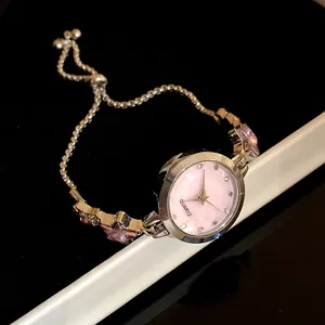 Close-up of an elegant ladies' fashion watch featuring pink star crystals and adjustable chain