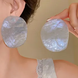 Oversized iridescent textured disc earrings with retro designer aesthetic for women