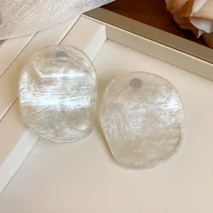 Macro detail of vintage translucent prawn cracker style stud earrings with unique texture