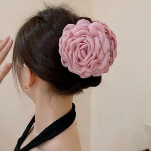 Large pink fabric rose hair claw clip for elegant women bun hairstyles accessory.