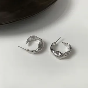 Irregular textured silver hoop earrings with a minimalist retro design for women.
