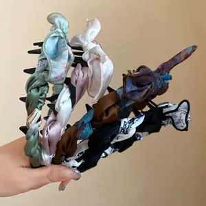 Vintage silk fabric wrapped bow headbands in various colors for elegant hair styling