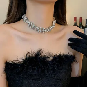 Sparkling silver twisted rhinestone choker necklace worn by a model in a black dress