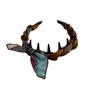 Elegant vintage silk scarf wrapped headband featuring a bow and spikes for high cranial top