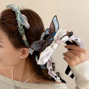 Side view of elegant fabric silk scarf headband with a vintage floral bow