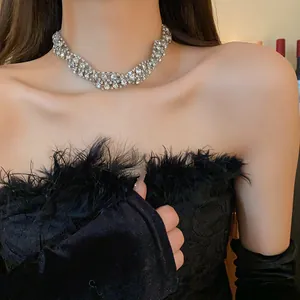 Close-up view of an elegant rhinestone twisted geometric choker necklace worn by a model.