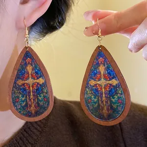 Vintage bohemian wooden teardrop earrings with colorful religious cross print for women.