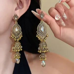Vintage gold-tone drop earrings with intricate crystal inlay and royal style