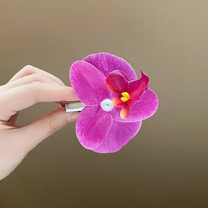 Elegant purple Phalaenopsis orchid hair clip with a central pearl bead for women