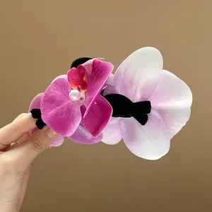 Elegant orchid flower hair claw clip with pearl detail for women in pink and purple