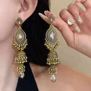 Elegant vintage gold Jhumka earrings with rhinestones for women, palace style design.