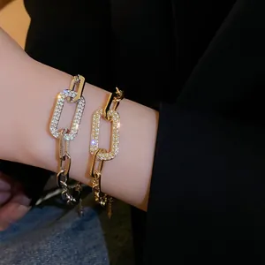Macro view of gold and silver geometric link bracelets with sparkling rhinestone accents