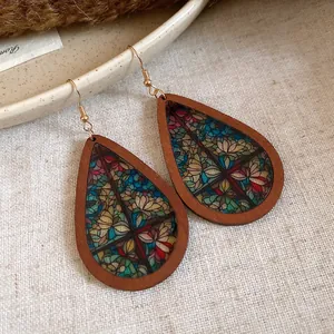 Detail view of Bohemian teardrop wooden earrings with vintage stained glass mosaic print