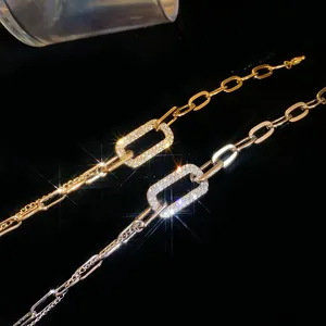 Macro detail of geometric chain bracelet with pavé-set sparkling rhinestones in gold and silver