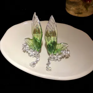 Elegant green insect wing earrings with sparkling rhinestone floral details for women