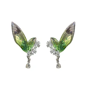 Elegant green fairy wing earrings adorned with sparkling rhinestones and teardrop crystals.