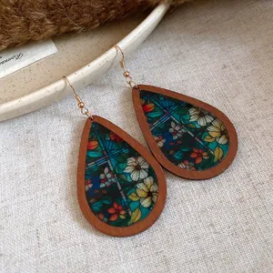 Close-up of bohemian wood teardrop earrings with colorful floral stained glass print