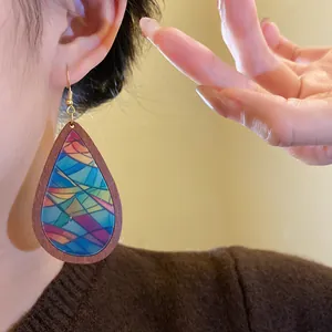 Close-up view of bohemian teardrop earrings featuring a vibrant colorful printed pattern