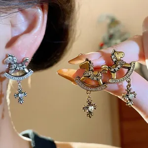 Vintage rocking horse stud earrings with zircon cross charms in gold and silver