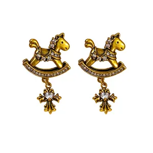 Vintage rocking horse stud earrings featuring dangling heart cross and clear zircons