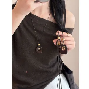 Detailed view of tiger eye resin pendant necklace showing smooth texture and earth tones