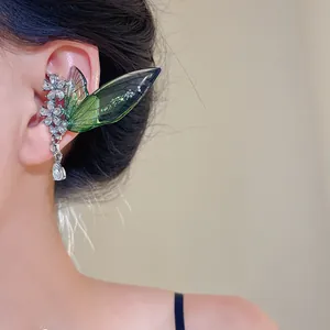 Elegant fairy wing ear cuff with crystals and green cicada wing detail shown on a model.