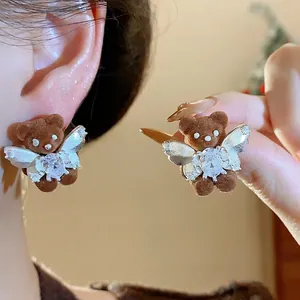 Adorable brown velvet teddy bear stud earrings with crystal wings and 18K gold plating.