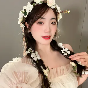 Ethereal white flower crown and matching hair accents worn by a model in Mori style.