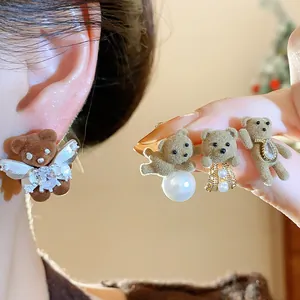 Detailed view of sweet flocked teddy bear earrings with pearls and 18K gold plated silver needles