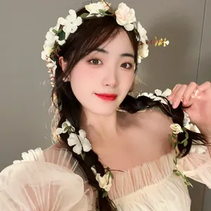 Elegant forest style floral garland headband with white flowers and leaves on a model