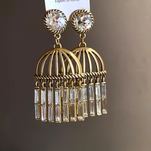 Close-up of vintage gold-finish tassel earrings with sparkling zircon stones