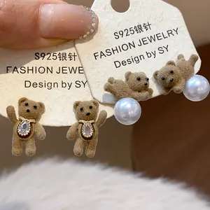 Detail view of sweet flocked bear earrings with pearls and 18K gold plated silver needles.